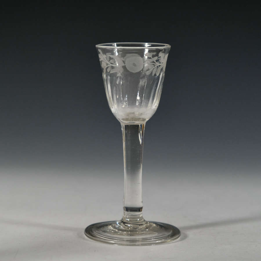 Plain stem wine glass with engraved bowl c1760